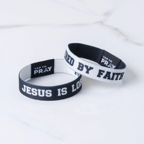 Two "Jesus Is Lord" "Tap To Pray" Wristbands on white background that shows the two reversible sides to the Wristbands