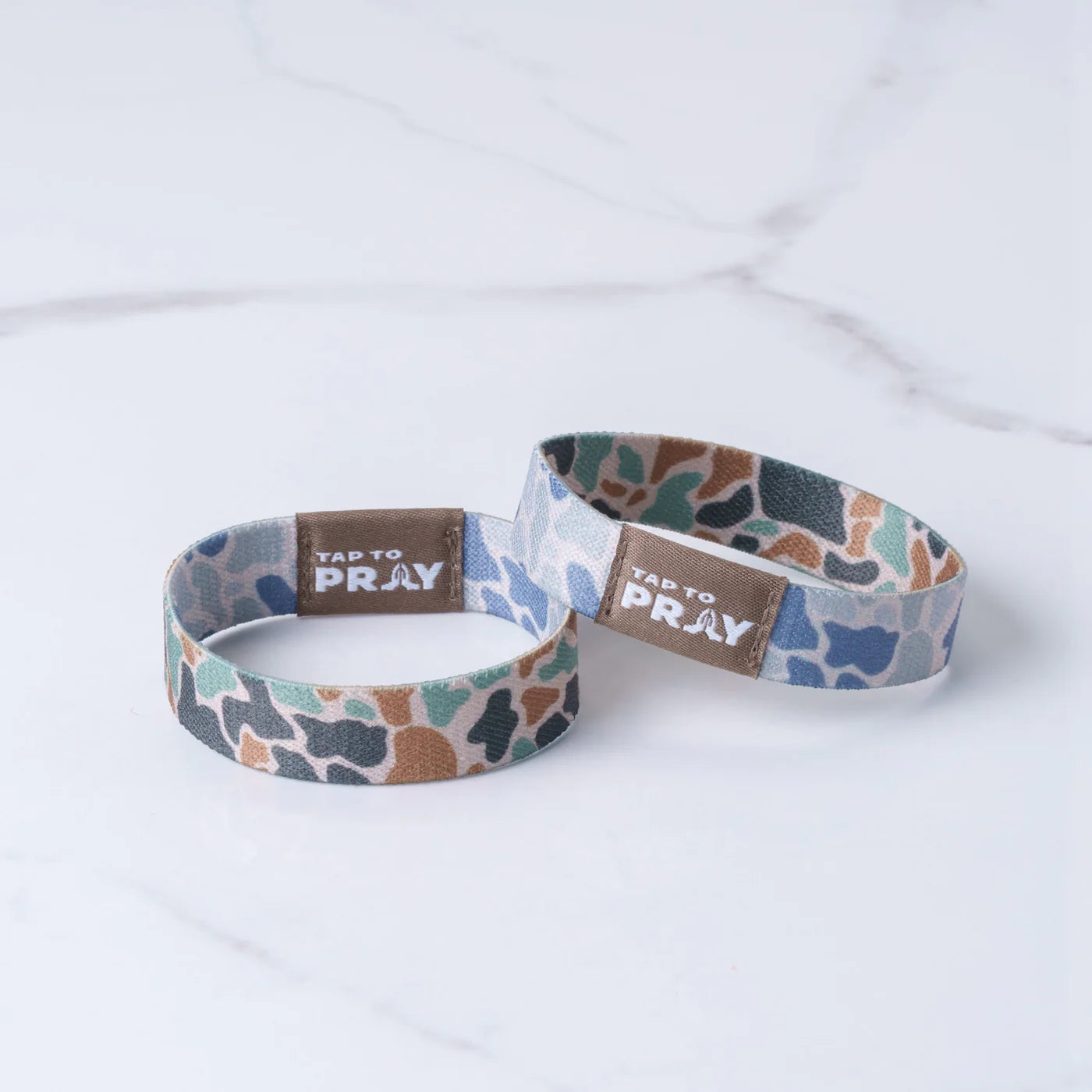 Two patterned wristbands with 'Tap to Pray' text on a white background