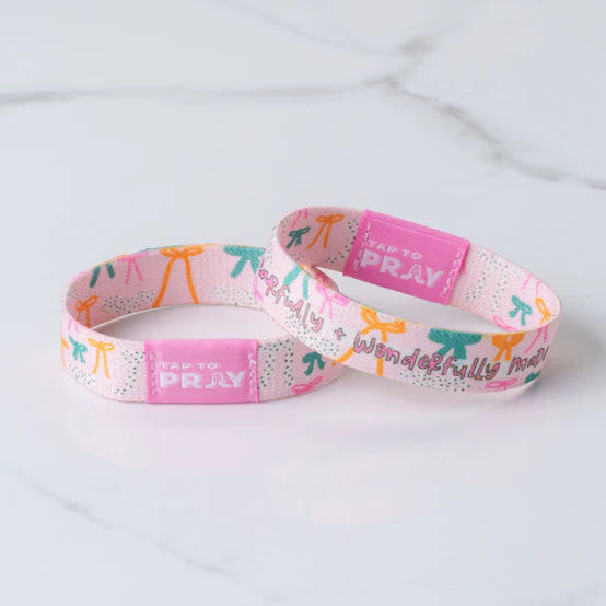"Tap To Pray" Fearfully & Wonderfully Made Wristbands on a white background showing the two reversible sides to it