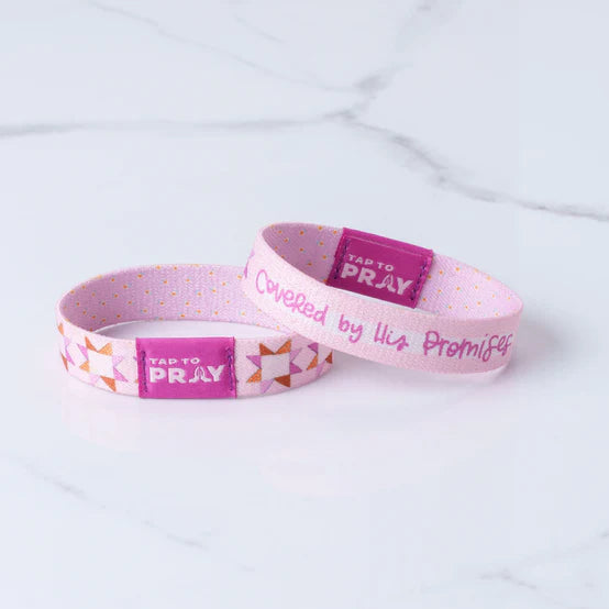 "Tap To Pray"Covered By His Promises Wristbands on a white background showing the two reversible sides to it
