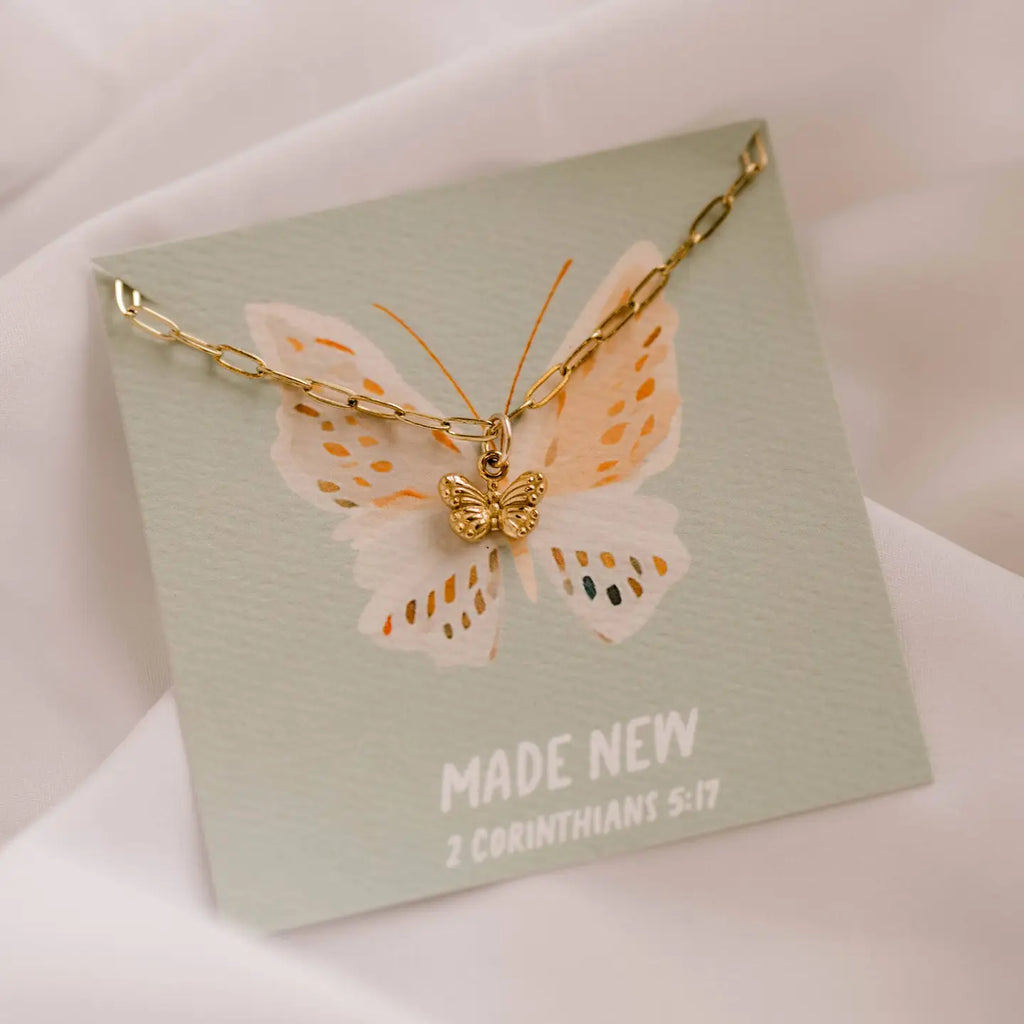 Butterfly necklace on a card with 'Made New' text