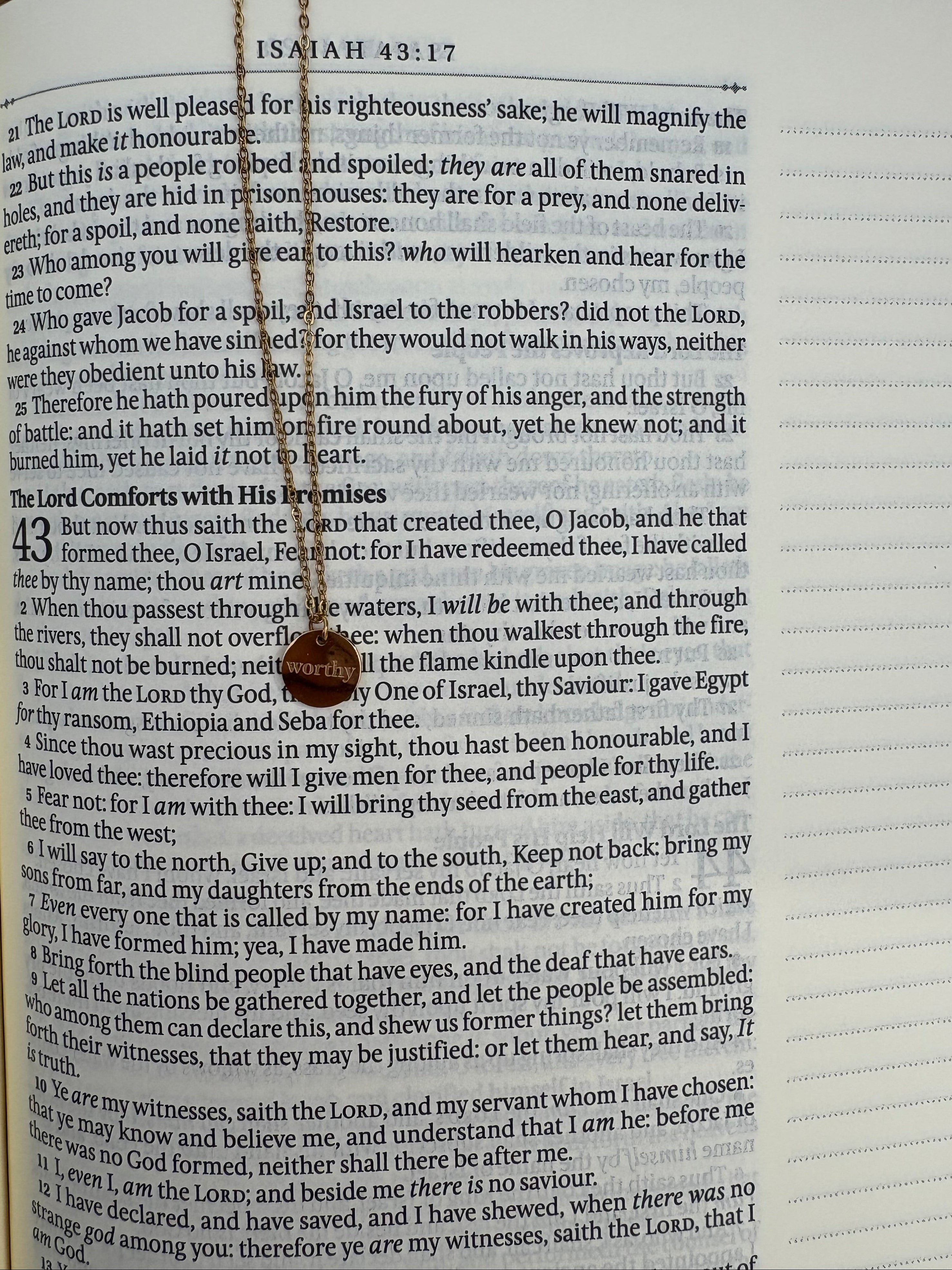 Necklace with a circular pendant on an open bible