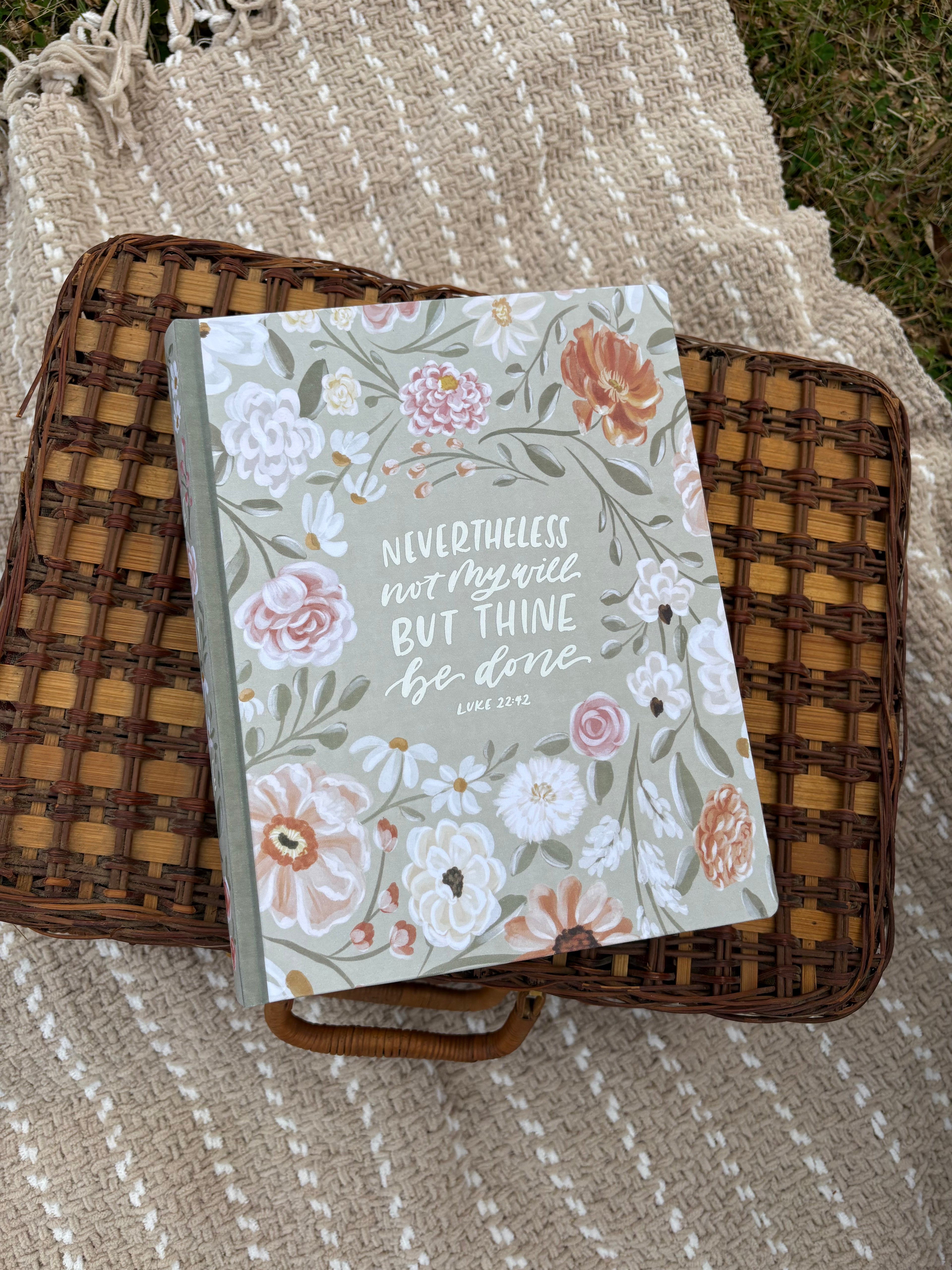 Floral Bible on a wicker basket with a textured blanket background