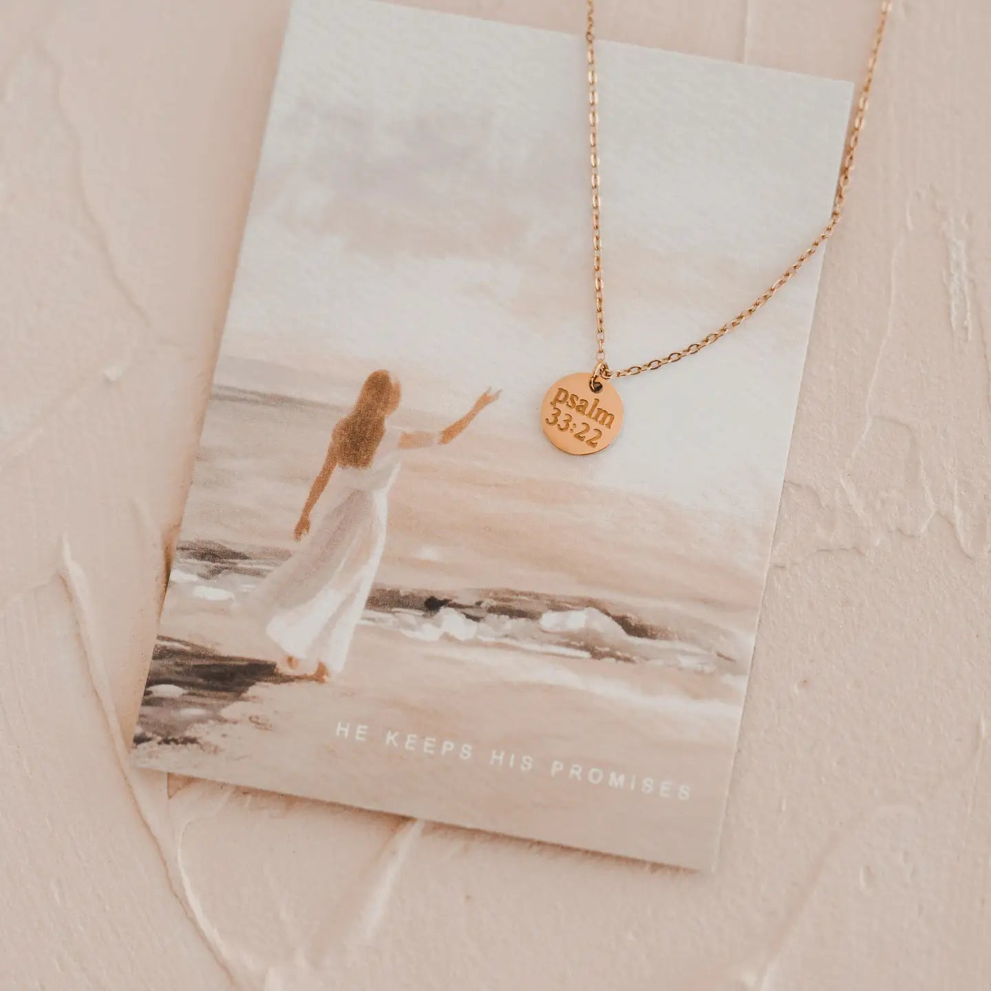 Necklace with a pendant on a card featuring an image of a woman on a beach.