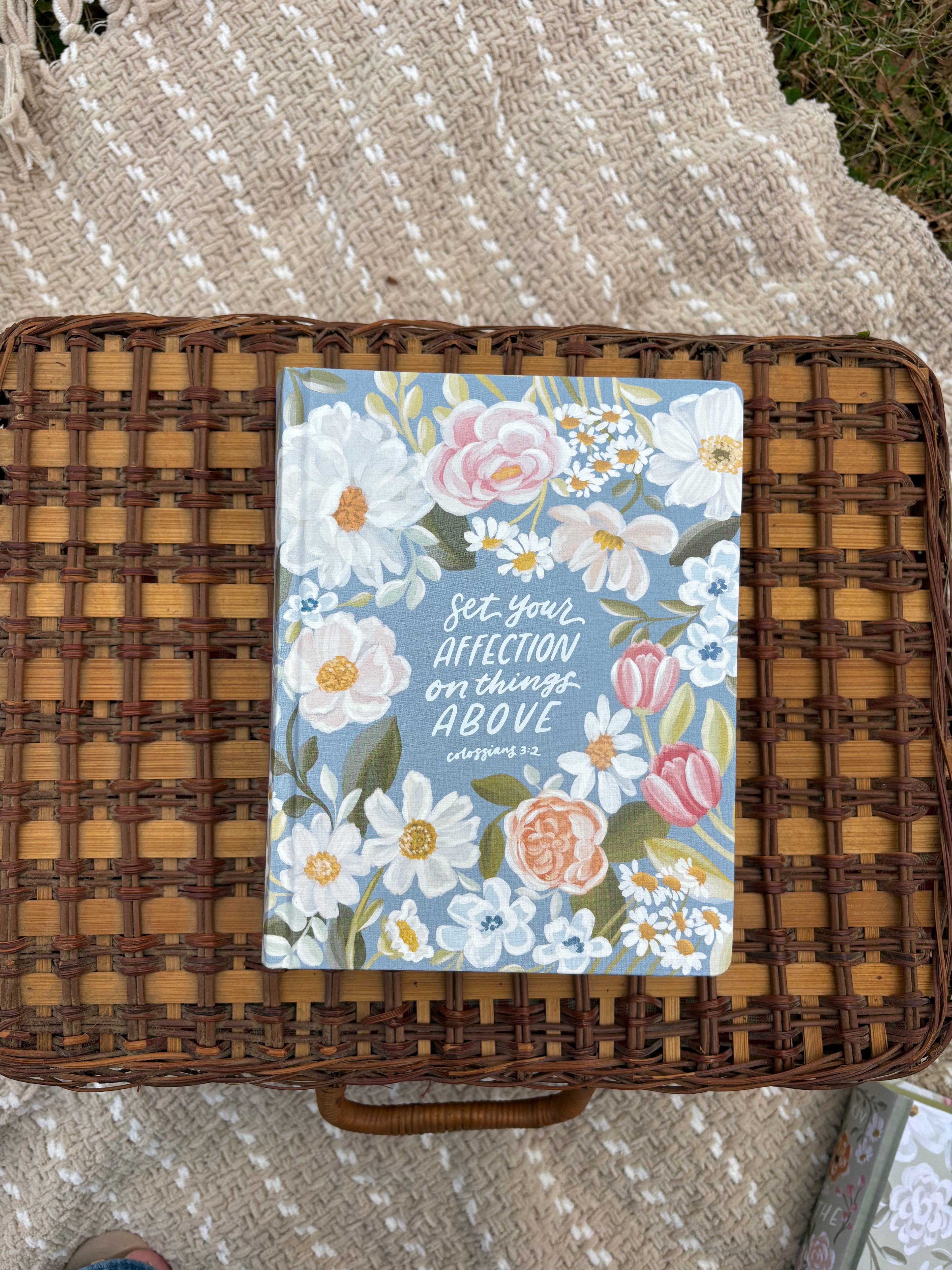 Floral bible on a wicker surface with text