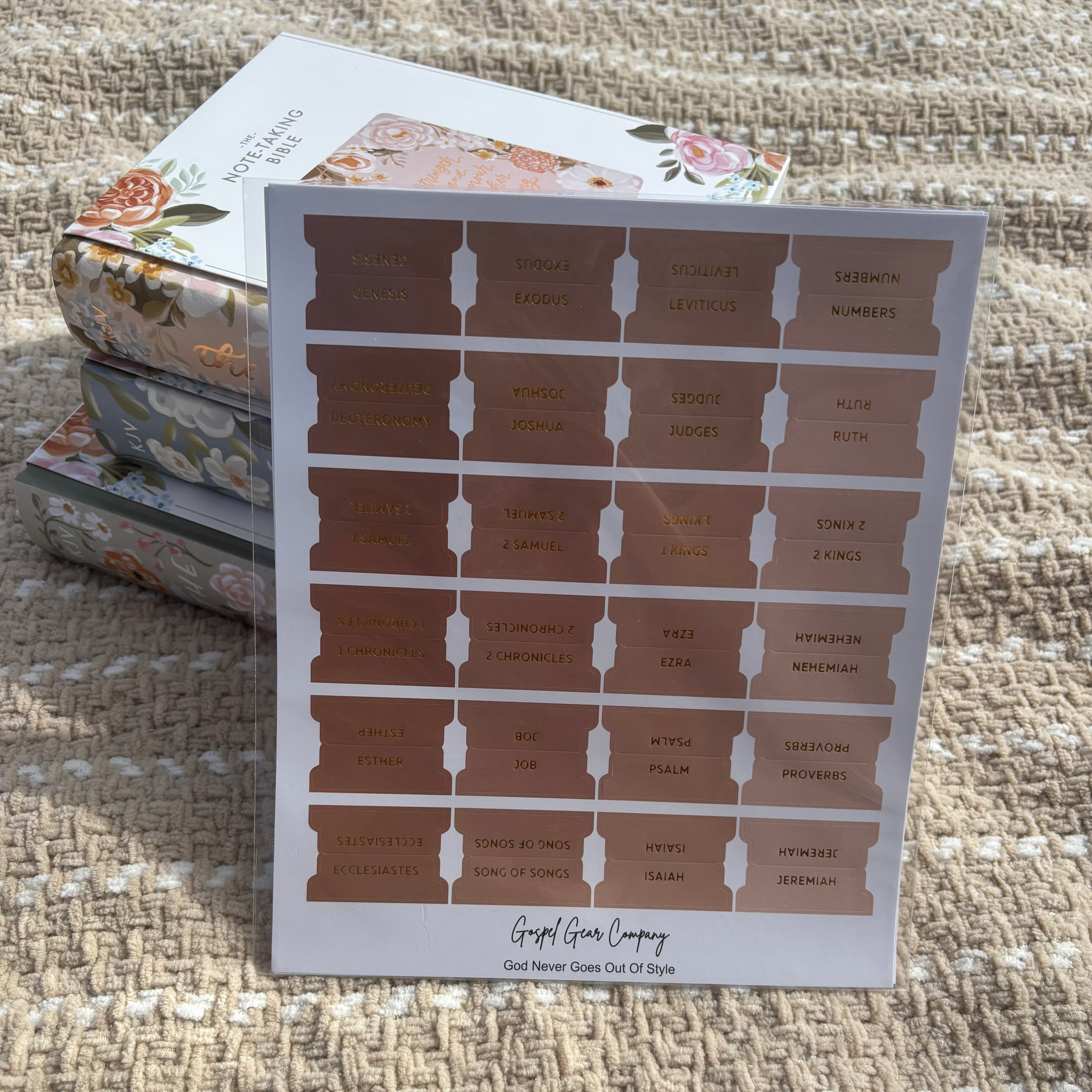 Sand Dune Bible tabs propped against floral Bibles laying on a beige blanket outside