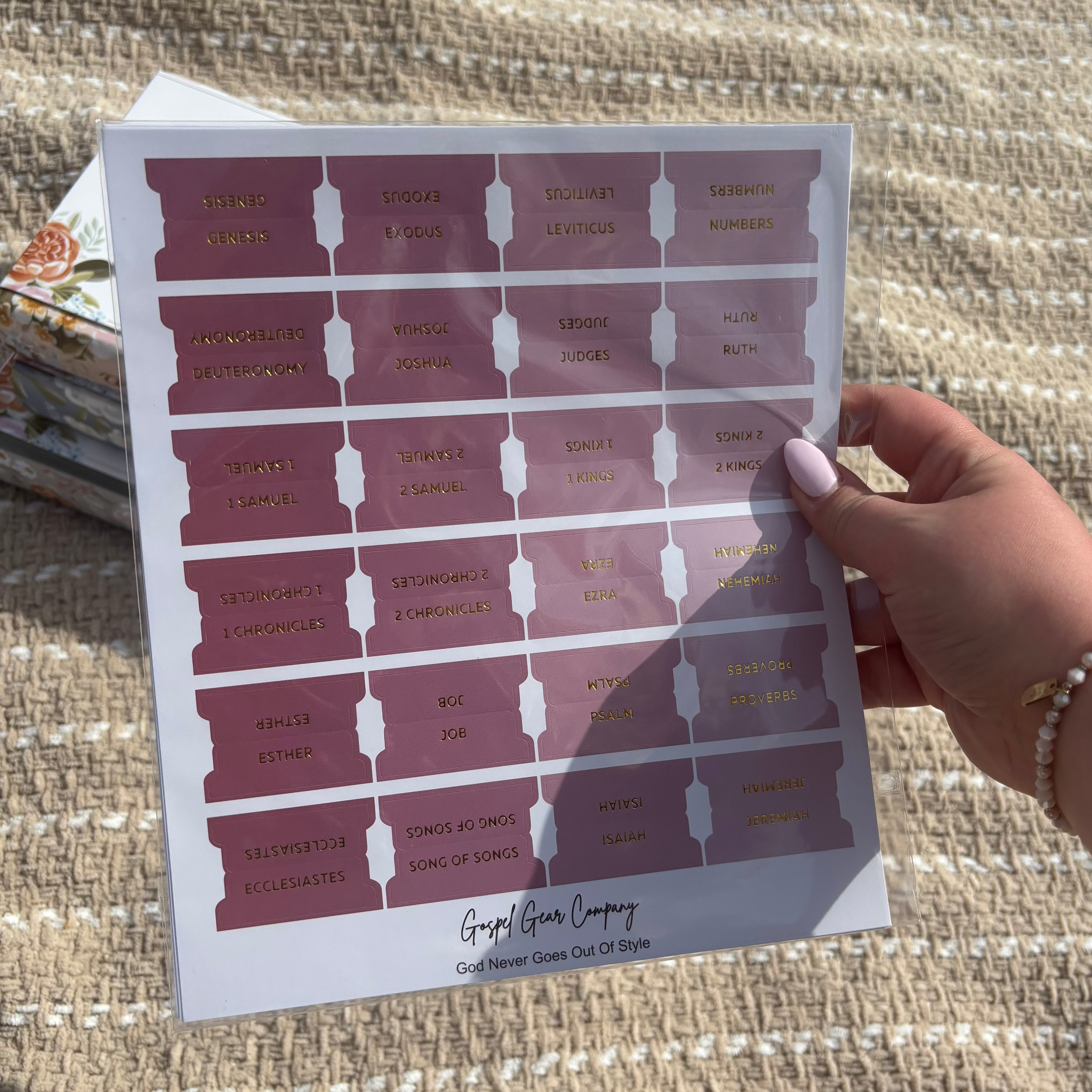 Dusty Rose Bible tabs with floral Bibles laying in the background on a beige blanket outside