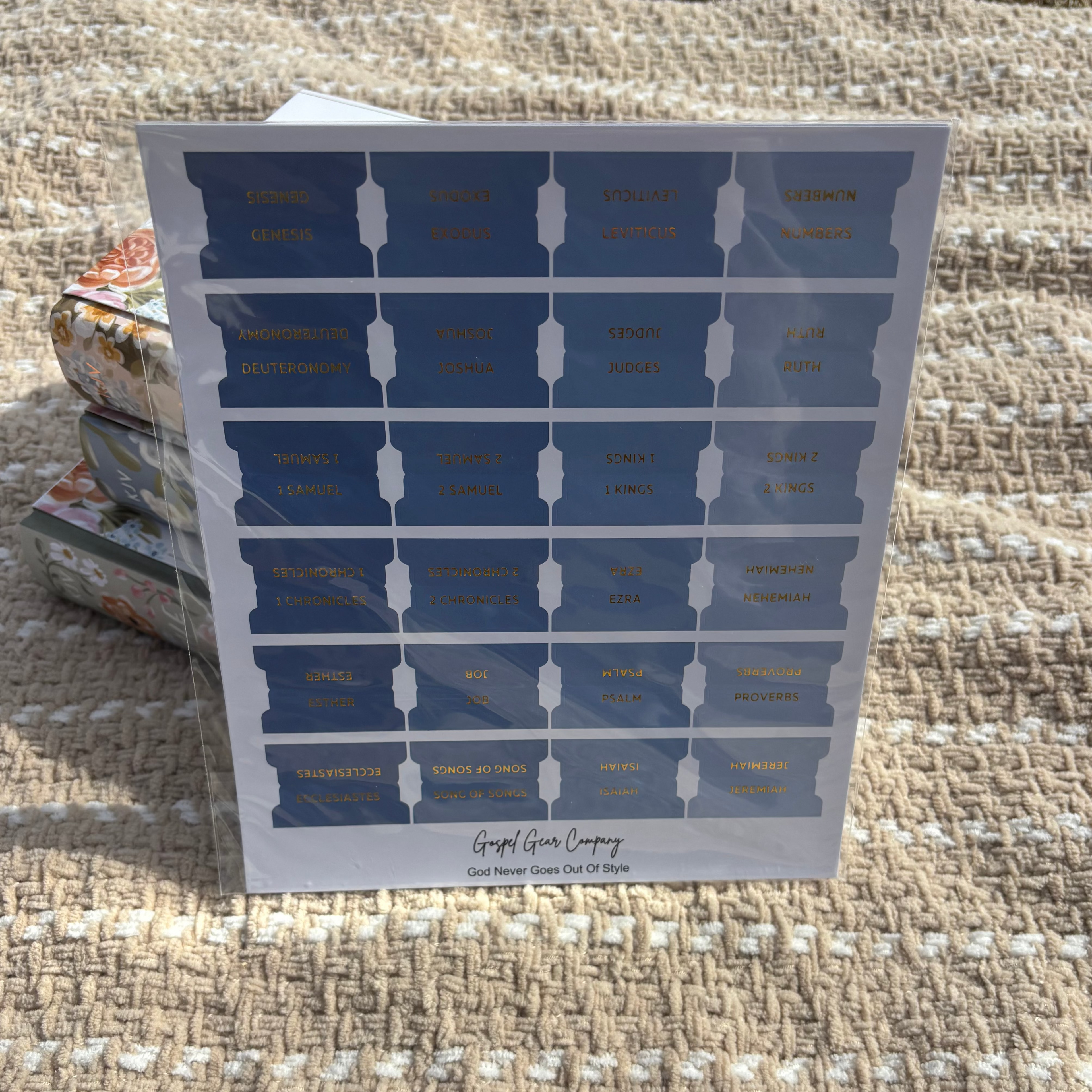 Ocean Blue Bible tabs propped against floral Bibles laying on a beige blanket outside