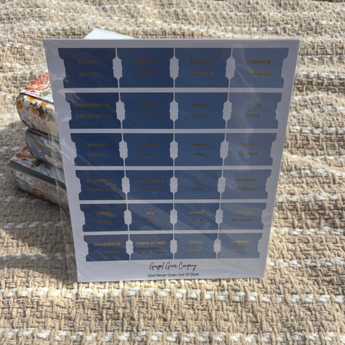 Ocean Blue Bible tabs propped against floral Bibles laying on a beige blanket outside