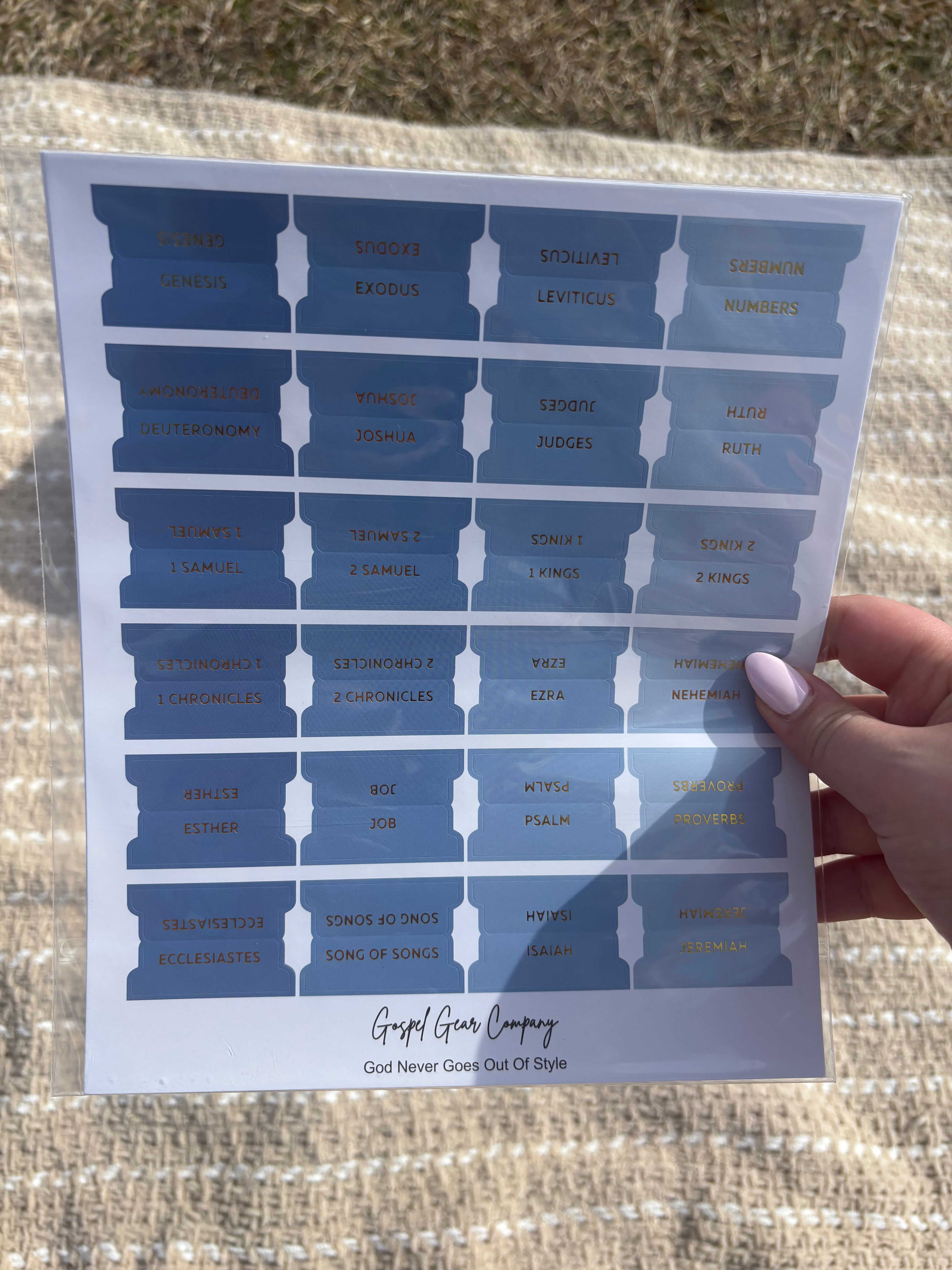 Ocean Blue Bible tabs with floral Bibles laying on a beige blanket outside