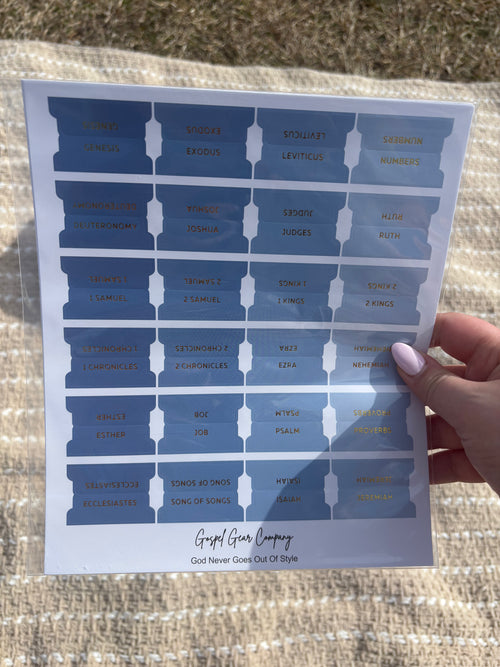 Ocean Blue Bible tabs with floral Bibles laying on a beige blanket outside