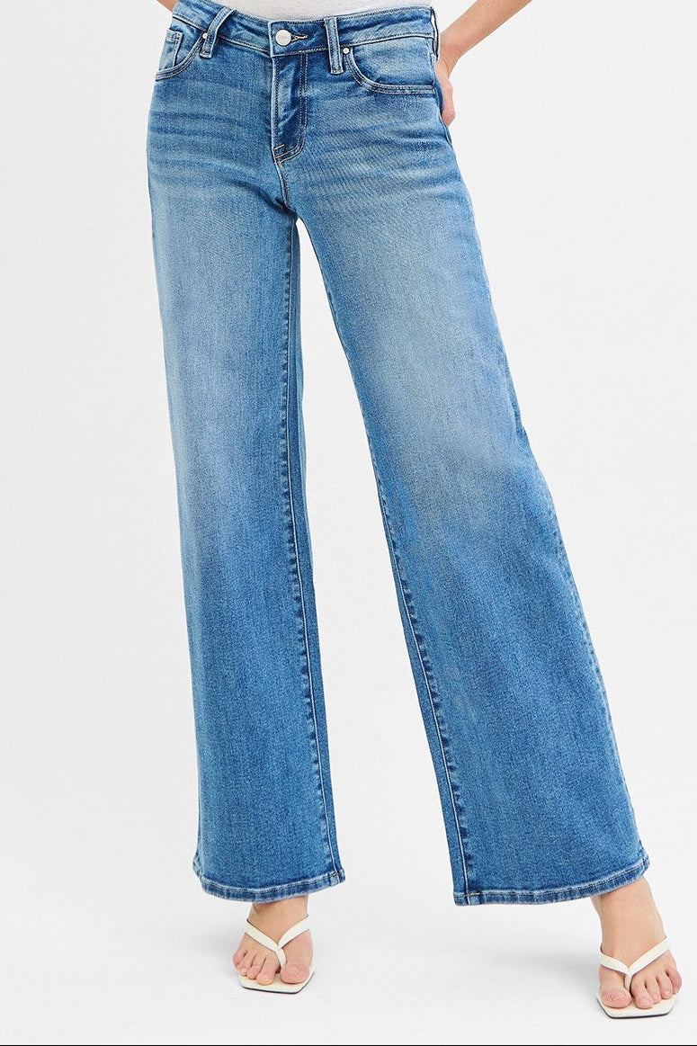 Blue jeans worn by a person on a white background