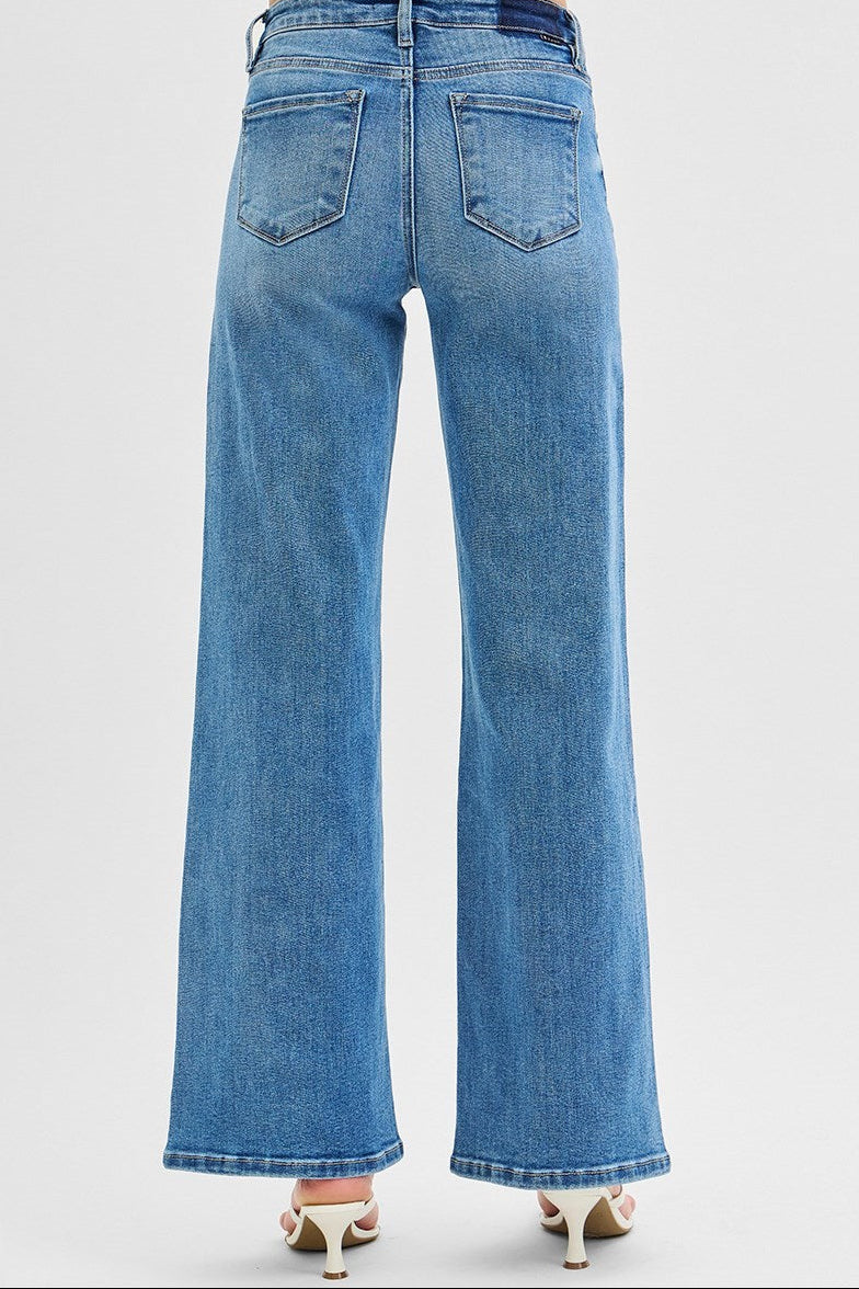Blue jeans worn by a person with a white background