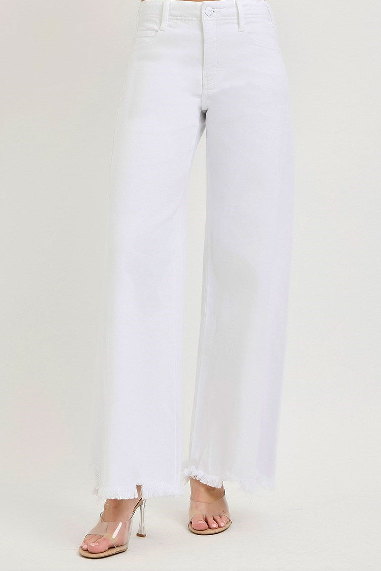 White jeans worn by a person on a white background