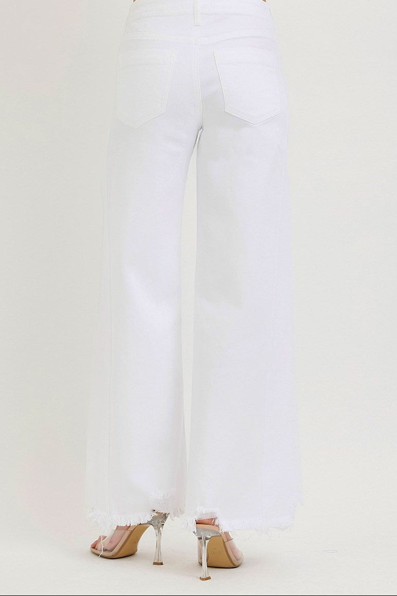 White pants worn with high-heeled shoes on a white background
