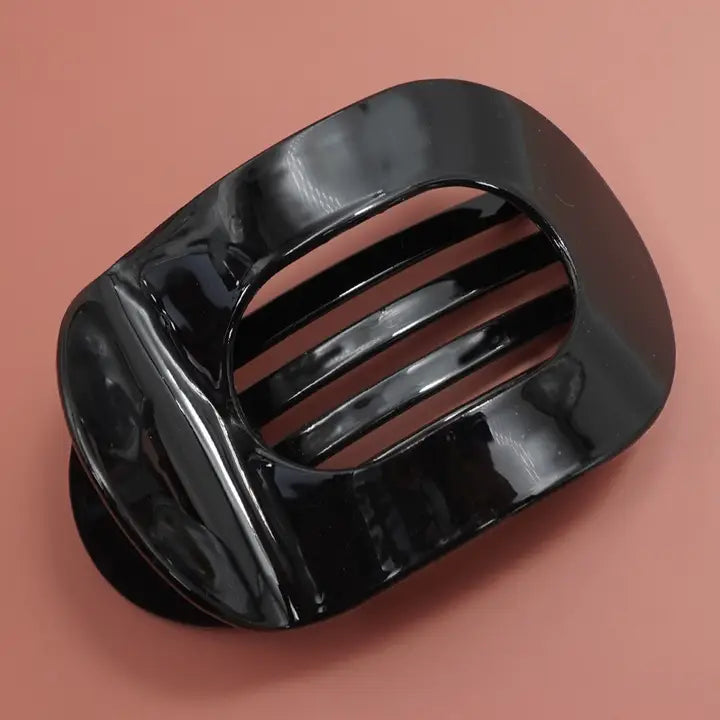 Black claw clip on a brown background